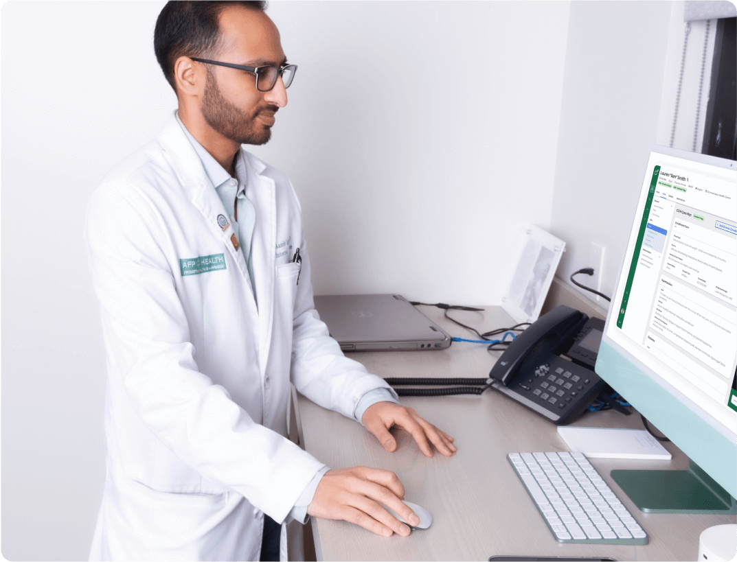 Doctor using computer at standing desk