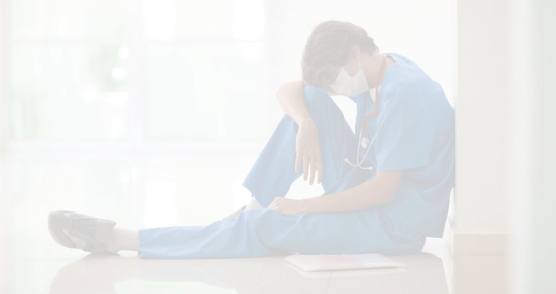 Tired nurse sitting on the ground