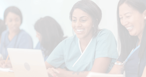 Nurses smiling and looking at laptop