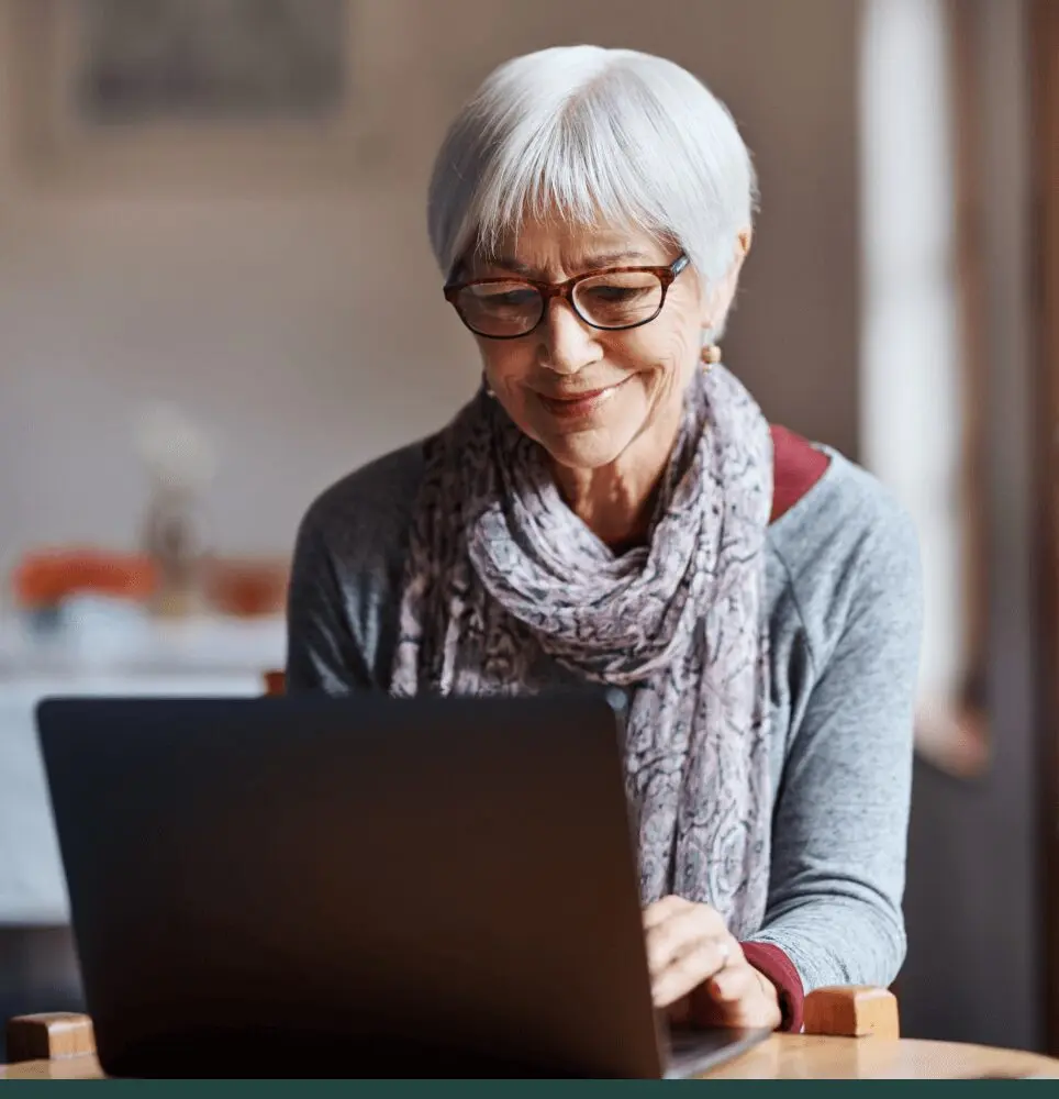 Woman with gray hair on laptop