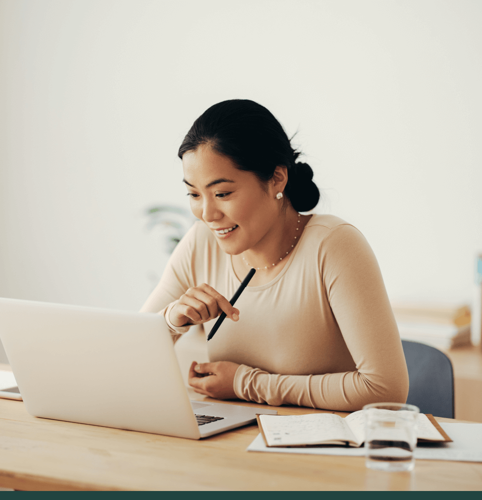 Woman smiling and looking on laptop